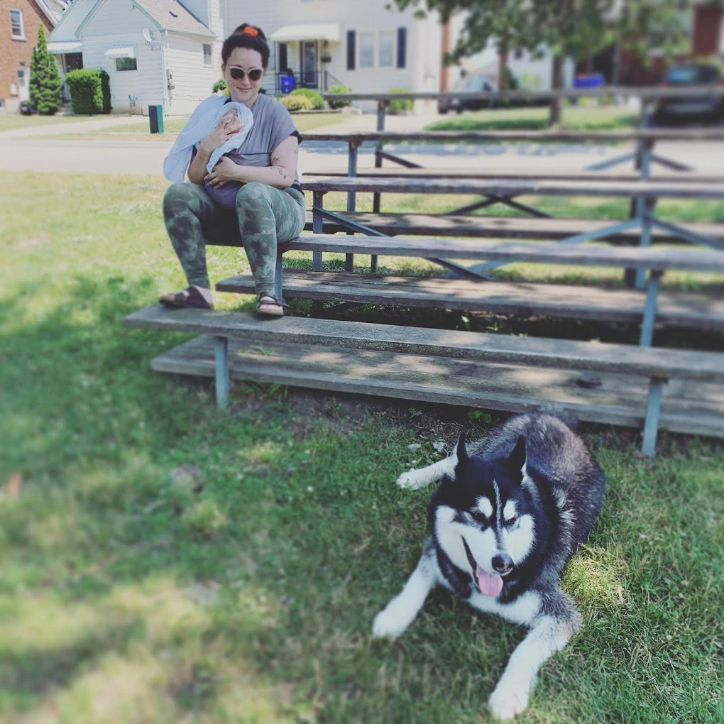 A neighborhood playground with a colorful climbing structure next to a baseball diamond.
